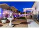 The backyard provides a tranquil spot, with string lights, a pergola, and ample space for outdoor enjoyment at 5534 E Player Pl, Mesa, AZ 85215