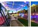 Inviting backyard featuring a covered patio with ambient lights, a swing, and outdoor seating at 5534 E Player Pl, Mesa, AZ 85215