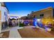 Expansive backyard with a pergola, decorative string lights, and ample seating areas for entertaining at 5534 E Player Pl, Mesa, AZ 85215