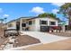 Charming home featuring a bridge walkway, black trim, and fresh flowers at 5534 E Player Pl, Mesa, AZ 85215