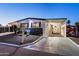 Well-maintained home with a landscaped yard, carport, and inviting walkway, showcasing its charming exterior appeal at 5534 E Player Pl, Mesa, AZ 85215