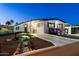 Charming manufactured home featuring a landscaped front yard with walkway and an inviting covered porch area at 5534 E Player Pl, Mesa, AZ 85215