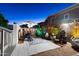 Charming patio featuring a dining set, cactus decor, patterned rug, and string lights for evening enjoyment at 5534 E Player Pl, Mesa, AZ 85215