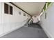 The covered patio features ample space with a sitting swing and stairwell access at 5534 E Player Pl, Mesa, AZ 85215