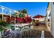 Inviting outdoor patio space features a dining set, decorative lighting, and colorful floral arrangements at 5534 E Player Pl, Mesa, AZ 85215