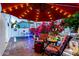 Cozy outdoor patio area with comfortable seating, a vibrant garden, and a shade umbrella at 5534 E Player Pl, Mesa, AZ 85215