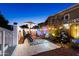 Cozy outdoor patio featuring a dining set, cactus decor, string lights, and relaxing water feature at 5534 E Player Pl, Mesa, AZ 85215