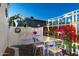 Outdoor patio area with dining set, trellises, and beautiful bougainvillea creating a serene and inviting ambiance at 5534 E Player Pl, Mesa, AZ 85215