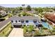 Aerial view of the home, featuring a spacious lot, a backyard pool, and mature trees at 6196 E Calle Camelia --, Scottsdale, AZ 85251