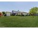 Expansive backyard with lush lawn and manicured landscaping, showcasing the home's exterior at 6196 E Calle Camelia --, Scottsdale, AZ 85251