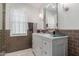 Beautiful bathroom featuring a white vanity, marble countertop, and tiled walls at 6196 E Calle Camelia --, Scottsdale, AZ 85251