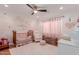 Cozy Bedroom with a crib, rocking chair, and soft pink accents at 6196 E Calle Camelia --, Scottsdale, AZ 85251