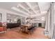 Elegant dining room with a long wooden table, bar area, and modern lighting fixtures at 6196 E Calle Camelia --, Scottsdale, AZ 85251