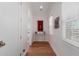 Bright hallway with hardwood floors, crisp white walls and trim leads to other rooms at 6196 E Calle Camelia --, Scottsdale, AZ 85251