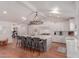 Bright kitchen with an oversized island including seating, hardwood floors, and modern appliances at 6196 E Calle Camelia --, Scottsdale, AZ 85251