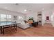 Inviting living room with a ping pong table, white sofa, and modern decor at 6196 E Calle Camelia --, Scottsdale, AZ 85251