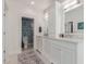 Bright main bathroom with double vanity with marble countertop and decorative tile flooring in toilet room at 6196 E Calle Camelia --, Scottsdale, AZ 85251