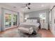Spacious main bedroom with outside views from French doors, accent rug, and ceiling fan at 6196 E Calle Camelia --, Scottsdale, AZ 85251