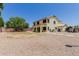Expansive gravel backyard featuring a two-story home with a covered patio at 6276 N 75Th Ln, Glendale, AZ 85303