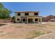 Backyard of a two-story home shows gravel landscaping, and a covered patio at 6276 N 75Th Ln, Glendale, AZ 85303