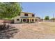 Expansive backyard showcases a two-story home, covered patio, and low-maintenance gravel landscaping at 6276 N 75Th Ln, Glendale, AZ 85303