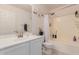 Bright bathroom featuring white cabinets, modern fixtures and shower-tub combination at 6276 N 75Th Ln, Glendale, AZ 85303