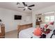 Spacious bedroom with wood bed frame, soft lighting and mirrored closet at 6276 N 75Th Ln, Glendale, AZ 85303