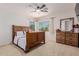 Serene bedroom with wooden bed, natural light, dresser, and modern ceiling fan at 6276 N 75Th Ln, Glendale, AZ 85303