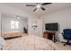 Bright bedroom featuring a mirrored closet, ceiling fan and modern furnishings at 6276 N 75Th Ln, Glendale, AZ 85303