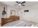 Nicely appointed bedroom with wooden bed frame, mirrored dresser, and white walls at 6276 N 75Th Ln, Glendale, AZ 85303