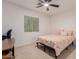 Comfortable bedroom with neutral tones, fan, and natural light from the window at 6276 N 75Th Ln, Glendale, AZ 85303