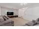 Open living room showcasing natural light, neutral carpet, and a large sectional couch at 6276 N 75Th Ln, Glendale, AZ 85303