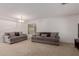 Spacious living room with neutral carpet, two sofas and bright window at 6276 N 75Th Ln, Glendale, AZ 85303