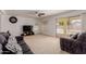 Relaxing living room with neutral carpet, ceiling fan, backyard view through sliding glass door at 6276 N 75Th Ln, Glendale, AZ 85303