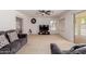 Spacious living room featuring neutral carpet, ceiling fan, and a view of the backyard at 6276 N 75Th Ln, Glendale, AZ 85303