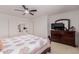Open bedroom with cozy carpet, fan and dresser with TV at 6276 N 75Th Ln, Glendale, AZ 85303