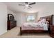 Spacious bedroom with cozy carpet, fan, and dresser with mirror at 6276 N 75Th Ln, Glendale, AZ 85303