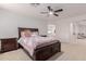 Open bedroom with cozy carpet, fan and access to the ensuite bath at 6276 N 75Th Ln, Glendale, AZ 85303