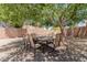 Inviting outdoor dining area with a table and six chairs shaded by a large tree at 6276 N 75Th Ln, Glendale, AZ 85303