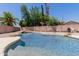 Sparkling pool with rock features and lush landscaping offers a serene backyard oasis at 6276 N 75Th Ln, Glendale, AZ 85303