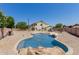 Private swimming pool and backyard featuring a rock waterfall and ample seating areas at 6276 N 75Th Ln, Glendale, AZ 85303
