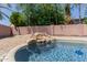 Backyard oasis highlighting a rock waterfall cascading into a sparkling pool at 6276 N 75Th Ln, Glendale, AZ 85303