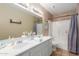 Inviting bathroom features double sinks, a large mirror, and a shower-tub combination for convenience at 6430 E Riverdale St, Mesa, AZ 85215