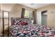 Cozy bedroom featuring a patterned bedspread, closet, and lots of natural light at 6430 E Riverdale St, Mesa, AZ 85215