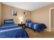 Comfortable bedroom features two twin beds with blue bedding, perfect for guests or children at 6430 E Riverdale St, Mesa, AZ 85215