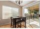 Cozy dining area features a modern table, seating four, with sliding glass doors opening to an outdoor patio at 6430 E Riverdale St, Mesa, AZ 85215