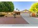 Inviting single-story home with a well-maintained yard, covered porch and mature trees offering great curb appeal at 6430 E Riverdale St, Mesa, AZ 85215