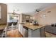 Open-concept kitchen with granite island, stainless steel appliances, and easy flow into the adjacent living area at 6430 E Riverdale St, Mesa, AZ 85215
