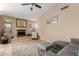 Comfortable living room showcasing vaulted ceilings, tile flooring, fireplace and neutral paint at 6430 E Riverdale St, Mesa, AZ 85215