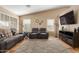 Comfortable living room with vaulted ceilings, two large windows and a decorative rug on tile floors at 6430 E Riverdale St, Mesa, AZ 85215